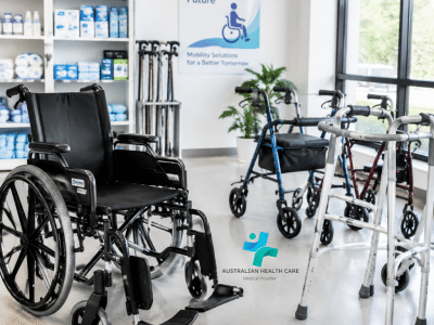 Four-wheel rollator walker with handles, brakes and a seat for mobility assistance.